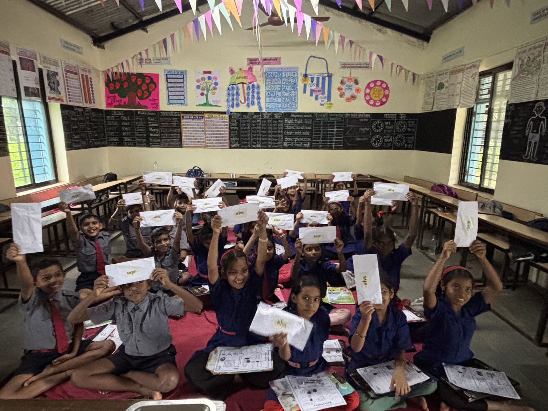 Students smiling and waving at the camera